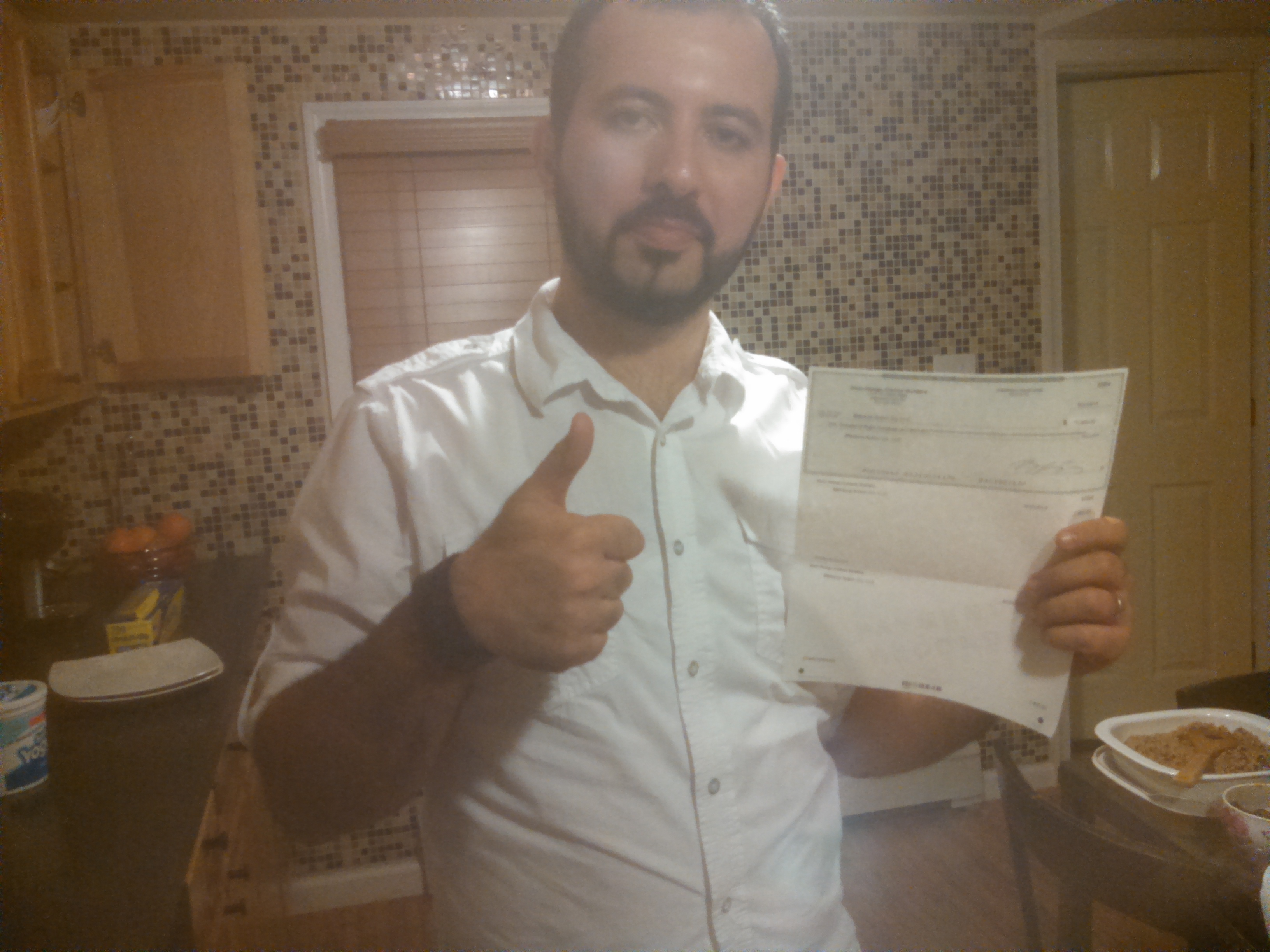 Oz Konar holding his first commission cheque